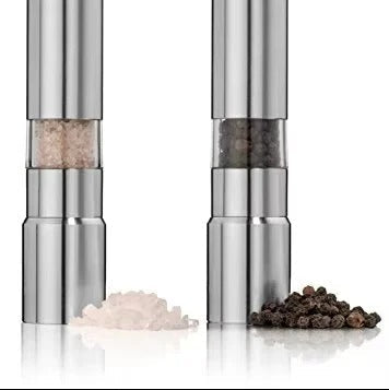 Two silver pepper mills with salt and pepper on a white background